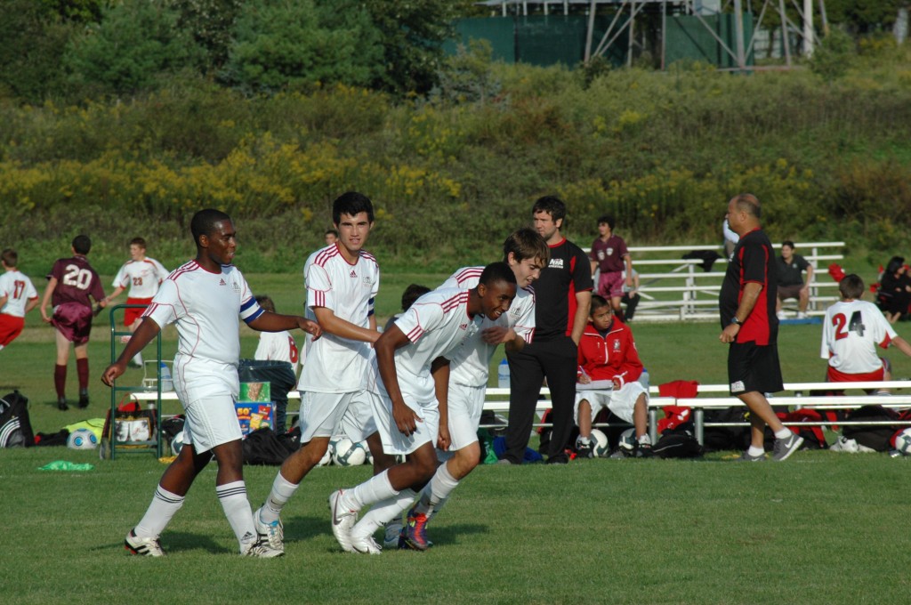 Coach James Morris, new head coach for boys varsity soccer, looks on as his team celebrates a goal scored by Nick Williams '13, in route to a 3-1 win over Nutley.